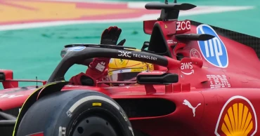 Lewis Hamilton waves to fans driving Ferrari F1