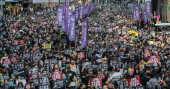 Thousands march as Hong Kong protests near half-year mark